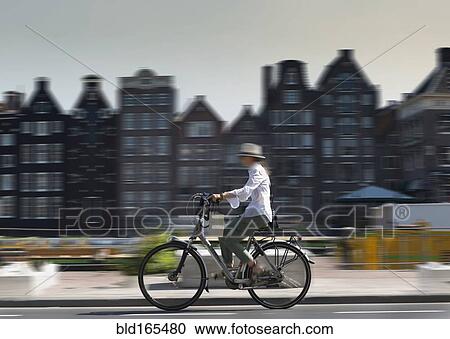 Blurred view of bicyclist on Amsterdam street, Netherland View Large Photo Image Stock Image - Blurred view of bicyclist on Amsterdam street, Netherland. Fotosearch