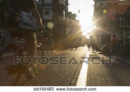 Stock Image - Blurred view of bicyclist on city street. Fotosearch