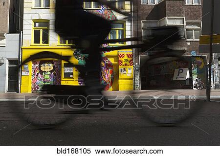 Stock Photography - Blurred view of bicyclist on city street. Fotosearch