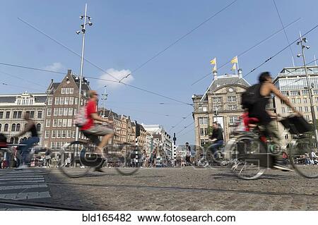 Stock Image - Blurred view of bicyclists on Amsterdam street, Netherland. Fotosearch