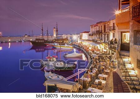 Stock Photography - Boats docked in urban harbor at night. Fotosearch