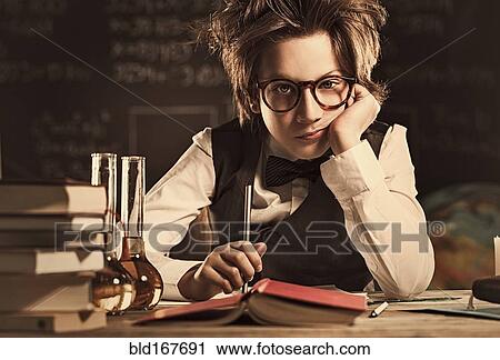 Stock Image - Bored student sitting at desk in classroom. Fotosearch