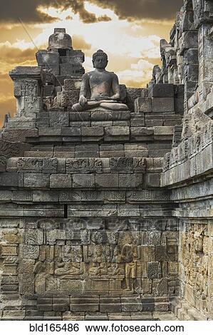Stock Photograph - Buddha statue on Temple of Borobudur, Borobudur, Indonesia. Fotosearch