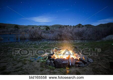 Burning campfire in remote field, Painted Hills, Oregon, United States View Large Photo Image Stock Photo - Burning campfire in remote field, Painted Hills, Oregon, United States. Fotosearch