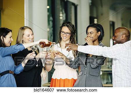 Business people celebrating with wine in office View Large Photo Image Stock Photo - Business people celebrating with wine in office. Fotosearch