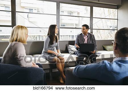 Picture - Business people having meeting in office lounge. Fotosearch