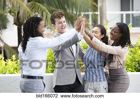 Business people high-fiving outdoors View Large Photo Image Stock Image - Business people high-fiving outdoors. Fotosearch