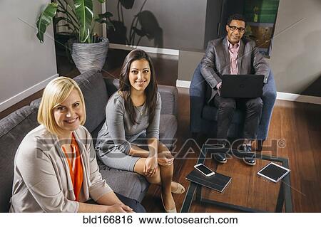 Business people sitting in office meeting View Large Photo Image Stock Photograph - Business people sitting in office meeting. Fotosearch