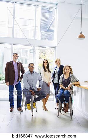 Stock Photo - Business people smiling in office. Fotosearch
