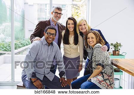 Stock Photo - Business people smiling in office. Fotosearch