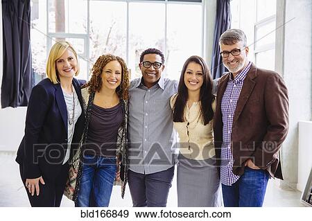 Stock Photo - Business people smiling in office. Fotosearch