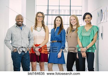 Stock Photography - Business people smiling in office. Fotosearch