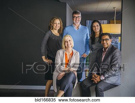 Stock Photography - Business people smiling in office. Fotosearch