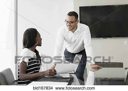 Picture - Business people talking in conference room. Fotosearch
