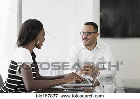 Stock Photo - Business people talking in conference room. Fotosearch