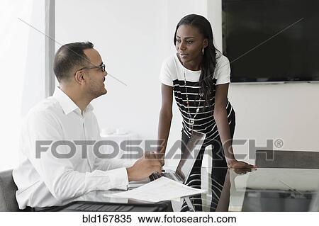 Stock Photography - Business people talking in conference room. Fotosearch