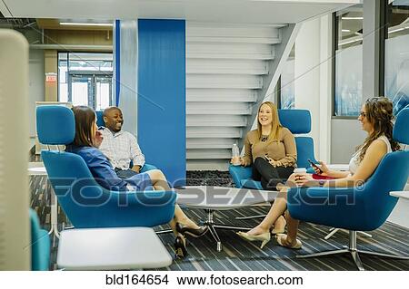 Business people talking in office lobby View Large Photo Image Picture - Business people talking in office lobby. Fotosearch