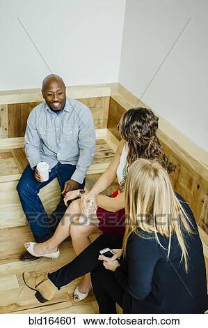 Business people talking in office lobby View Large Photo Image Stock Image - Business people talking in office lobby. Fotosearch