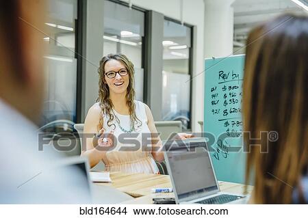 Business people talking in office meeting View Large Photo Image Picture - Business people talking in office meeting. Fotosearch
