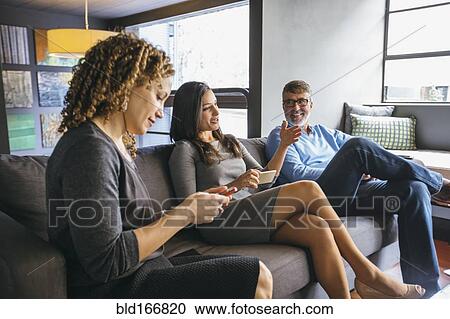 Stock Image - Business people talking in office meeting. Fotosearch