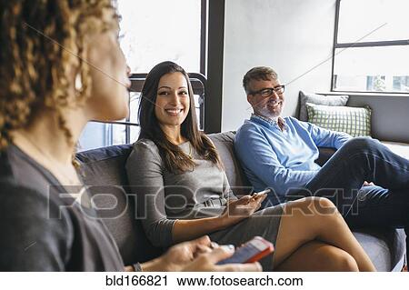 Stock Image - Business people talking in office meeting. Fotosearch