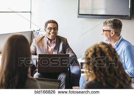 Stock Photograph - Business people talking in office meeting. Fotosearch