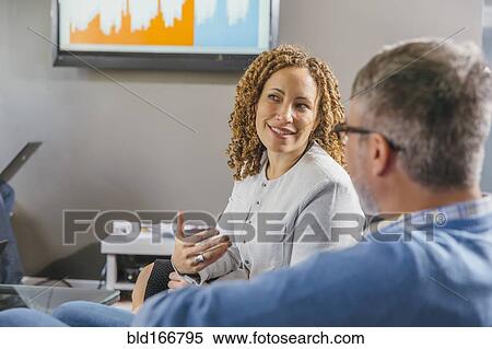 Stock Photography - Business people talking in office meeting. Fotosearch
