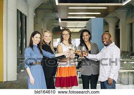 Business people toasting with wine in office View Large Photo Image Stock Image - Business people toasting with wine in office. Fotosearch