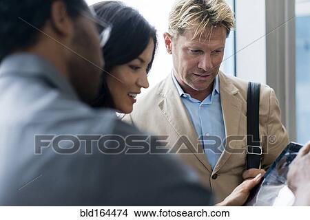 Business people using digital tablet in office View Large Photo Image Picture - Business people using digital tablet in office. Fotosearch