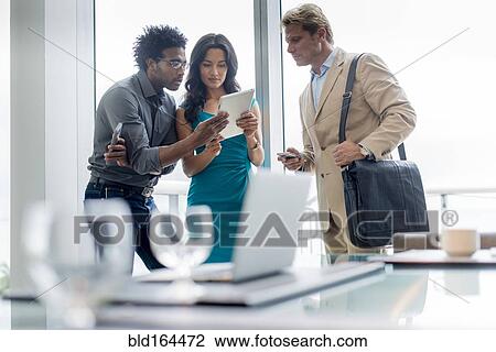 Business people using digital tablet in conference room View Large Photo Image Stock Image - Business people using digital tablet in conference room. Fotosearch