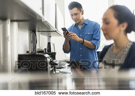Business people using technology in office View Large Photo Image Stock Photography - Business people using technology in office. Fotosearch