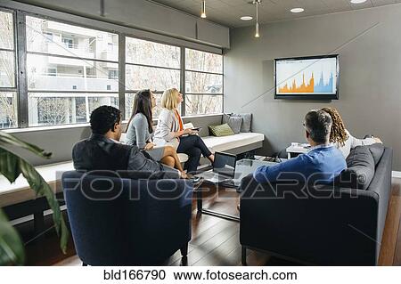 Business people watching presentation in office lounge View Large Photo Image Stock Image - Business people watching presentation in office lounge. Fotosearch