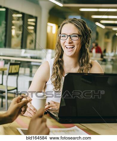 Picture - Business people working together in cafe. Fotosearch