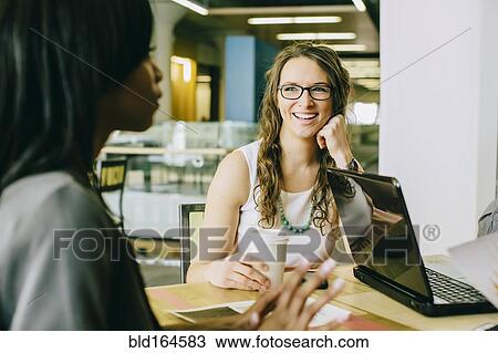 Business people working together in cafe View Large Photo Image Stock Image - Business people working together in cafe. Fotosearch