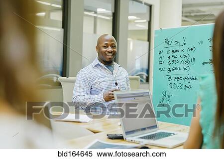 Stock Photography - Businessman talking in office meeting. Fotosearch