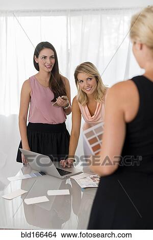 Picture - Businesswomen talking in office. Fotosearch