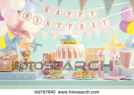 Stock Image - Cake, candy and gifts at birthday party. Fotosearch