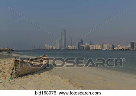 Canoe on beach near city skyline, Abu Dhabi Emirate, United Arab Emirates View Large Photo Image Stock Photograph - Canoe on beach near city skyline, Abu Dhabi Emirate, United Arab Emirates. Fotosearch