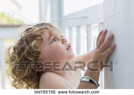 Caucasian baby boy leaning on wall View Large Photo Image Stock Photograph - Caucasian baby boy leaning on wall. Fotosearch