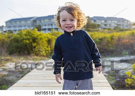Caucasian baby boy on wooden walkway on beach View Large Photo Image Stock Image - Caucasian baby boy on wooden walkway on beach. Fotosearch