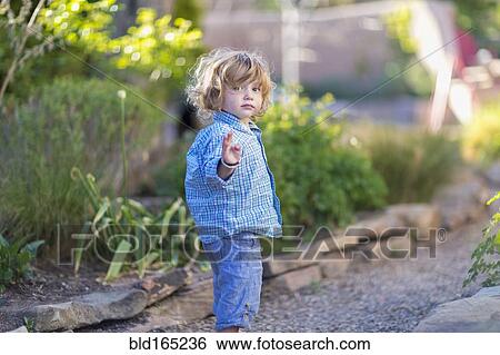 Caucasian baby boy playing in garden View Large Photo Image Stock Photograph - Caucasian baby boy playing in garden. Fotosearch