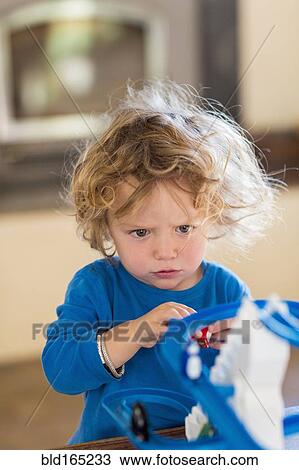 Caucasian baby boy playing with toy in living room View Large Photo Image Stock Image - Caucasian baby boy playing with toy in living room. Fotosearch