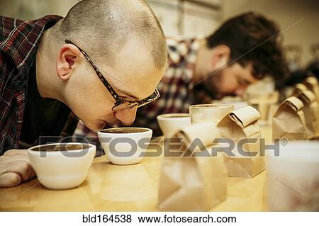 Caucasian baristas smelling coffee in cups View Large Photo Image Stock Photo - Caucasian baristas smelling coffee in cups. Fotosearch