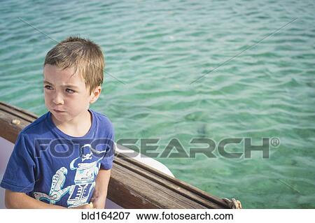 Caucasian boy on boat in water View Large Photo Image Stock Photo - Caucasian boy on boat in water. Fotosearch
