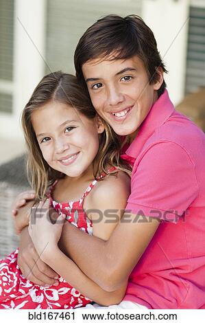 Caucasian brother and sister hugging on porch View Large Photo Image Stock Image - Caucasian brother and sister hugging on porch. Fotosearch