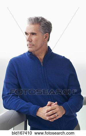 Stock Image - Caucasian businessman overlooking view from balcony. Fotosearch