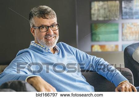 Stock Photo - Caucasian businessman smiling in office lobby. Fotosearch