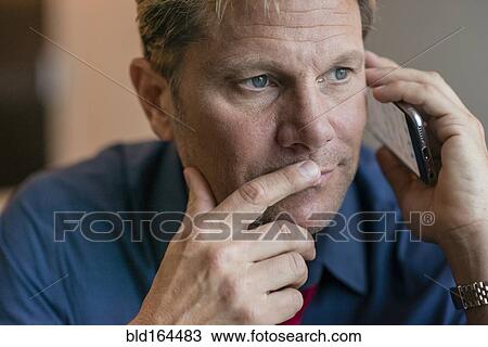 Stock Image - Caucasian businessman talking on cell phone. Fotosearch