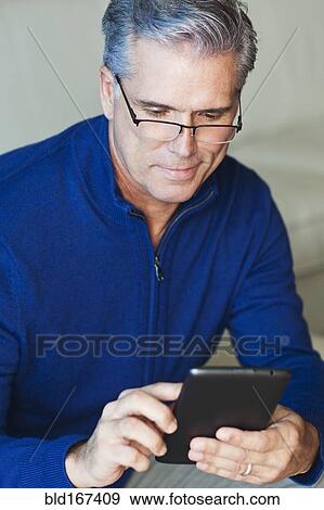 Caucasian businessman using digital tablet View Large Photo Image Stock Photo - Caucasian businessman using digital tablet. Fotosearch