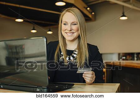 Caucasian businesswoman shopping online in cafe View Large Photo Image Stock Photo - Caucasian businesswoman shopping online in cafe. Fotosearch